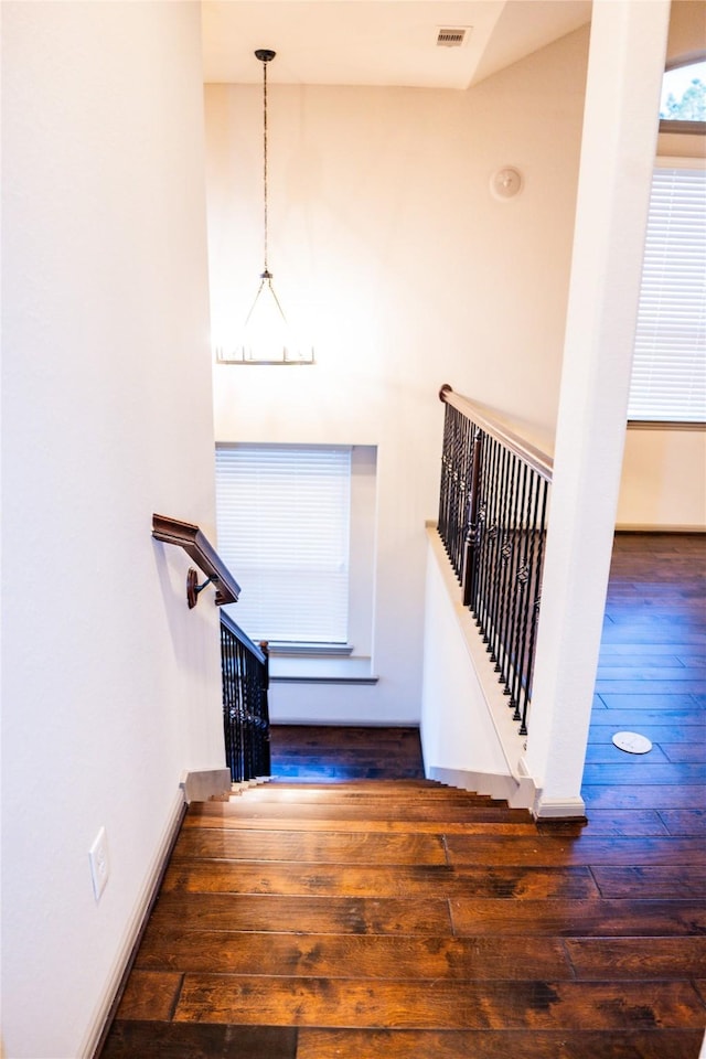 stairs featuring visible vents and hardwood / wood-style flooring