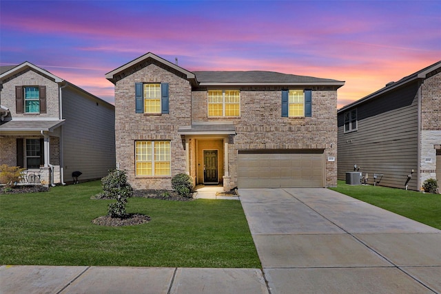 traditional home with brick siding, a lawn, an attached garage, cooling unit, and driveway