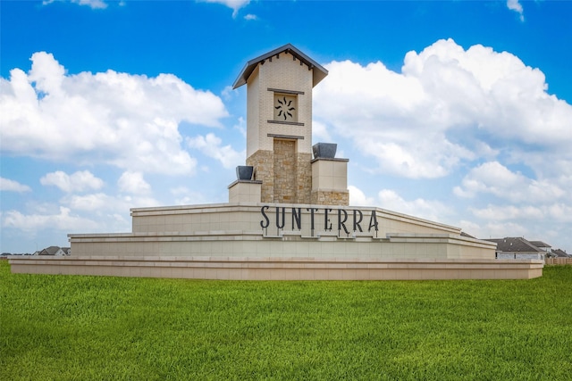 community sign featuring a yard