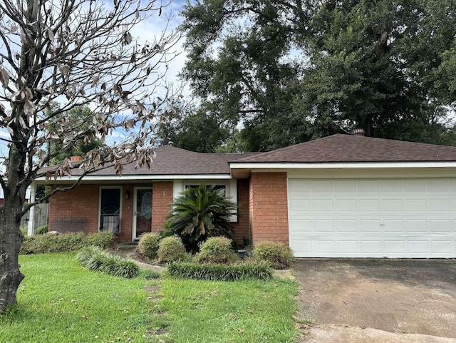 ranch-style house featuring a garage, driveway, brick siding, and a front lawn