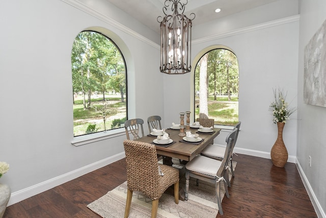 dining space with baseboards, arched walkways, dark wood-style floors, a notable chandelier, and recessed lighting