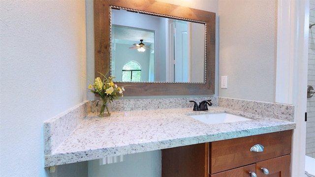 bathroom with toilet, ceiling fan, and vanity