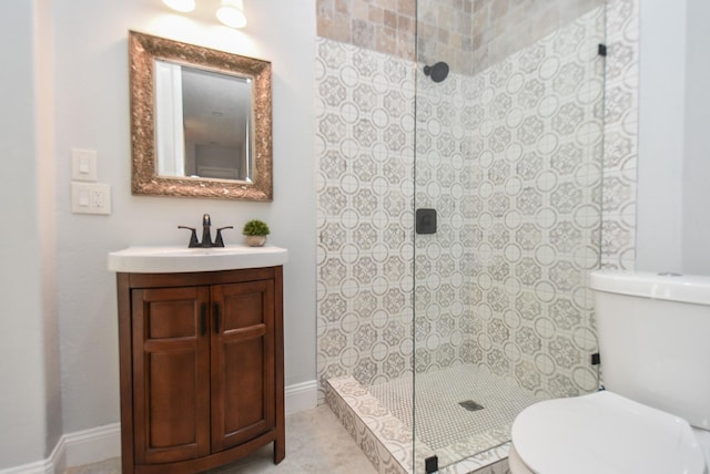 bathroom featuring baseboards, vanity, toilet, and walk in shower