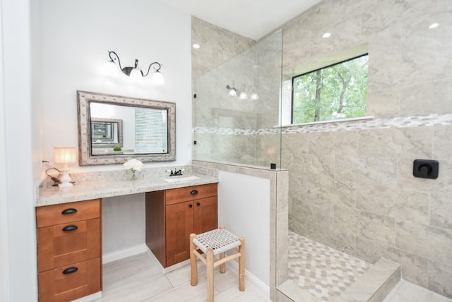 bathroom with walk in shower and vanity