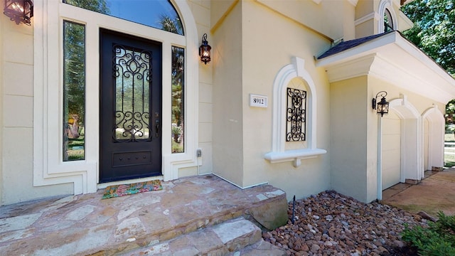 entrance to property featuring stucco siding