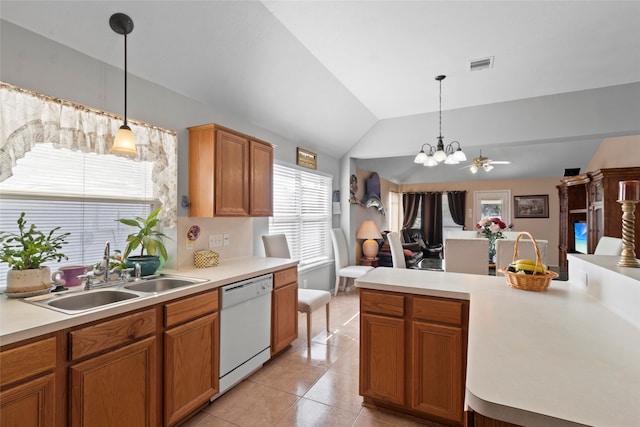 kitchen featuring light countertops, hanging light fixtures, white dishwasher, and a sink