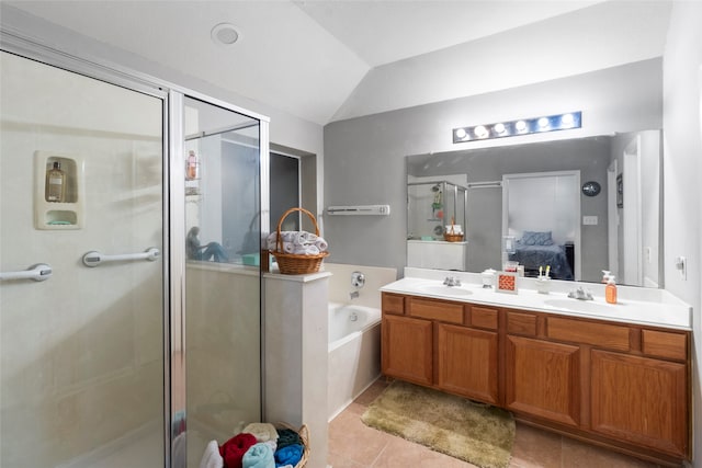 full bathroom featuring vaulted ceiling, connected bathroom, a shower stall, and a sink