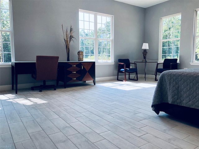 bedroom with light wood-type flooring and baseboards