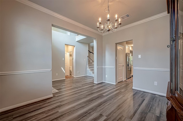 unfurnished dining area featuring ornamental molding, stairway, wood finished floors, and baseboards