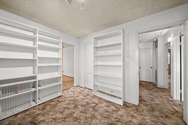 spacious closet with carpet flooring and attic access