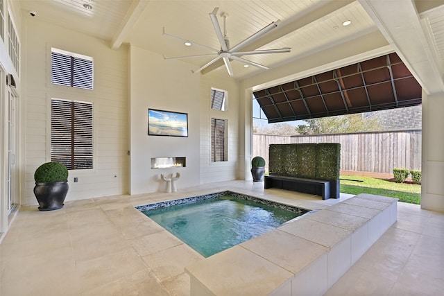 view of pool featuring a ceiling fan, an in ground hot tub, fence, and a patio