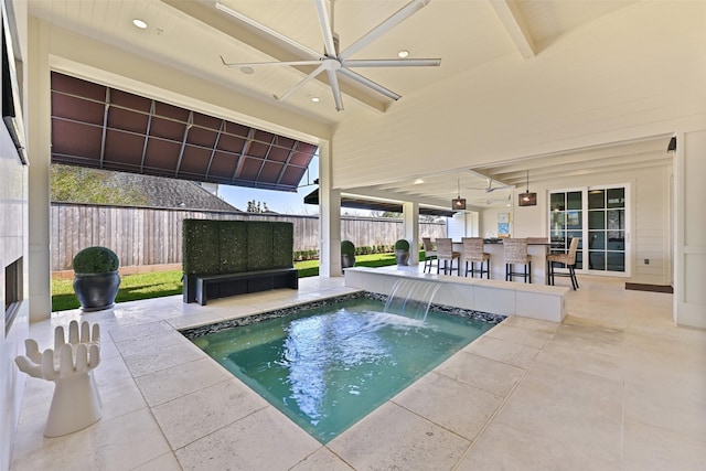 view of swimming pool featuring a patio, outdoor dry bar, a pool, a ceiling fan, and a fenced backyard