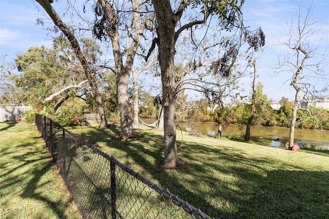 view of yard featuring a water view and fence