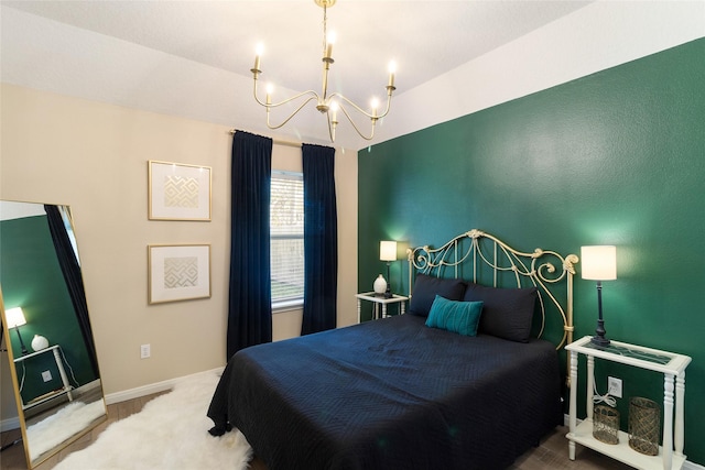 bedroom with carpet floors, an inviting chandelier, and baseboards