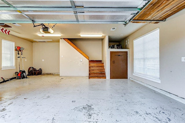 garage with a garage door opener and visible vents