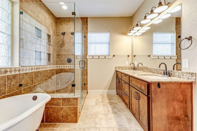 full bath featuring a healthy amount of sunlight, a soaking tub, a sink, and a shower stall