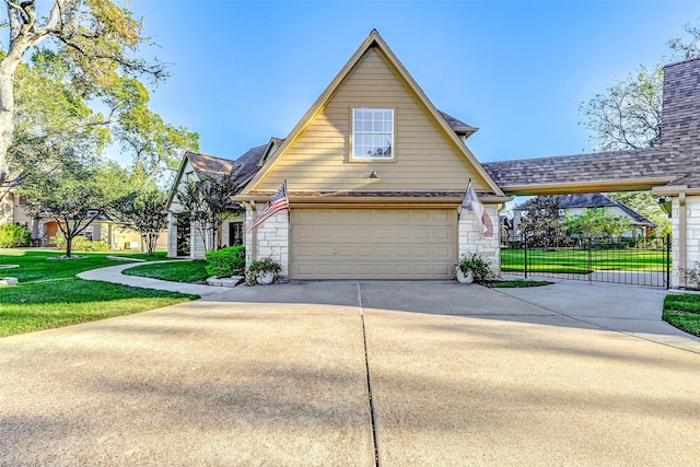 exterior space with driveway, stone siding, a garage, and a yard