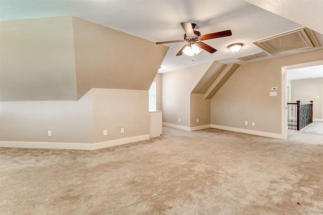 bonus room featuring lofted ceiling, light colored carpet, visible vents, attic access, and baseboards