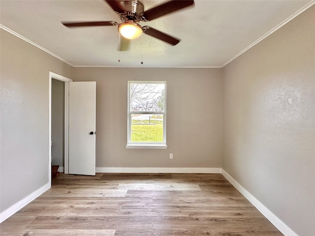 unfurnished room with ornamental molding, ceiling fan, light wood-style flooring, and baseboards