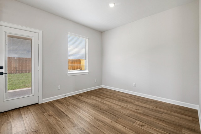 empty room featuring baseboards and wood finished floors