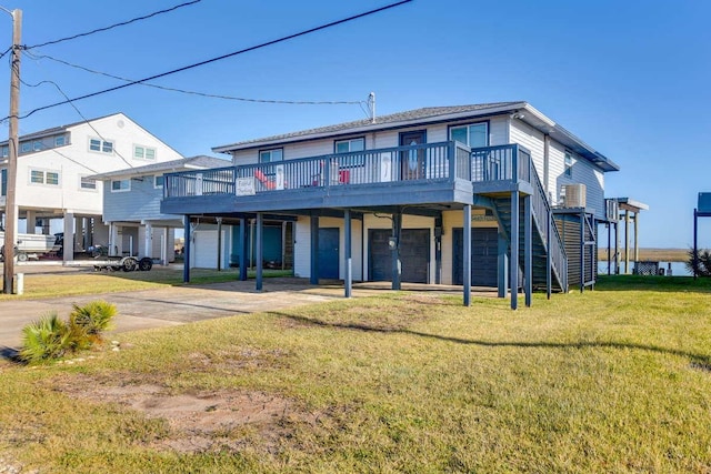 view of front of property featuring a front yard, a carport, driveway, a wooden deck, and stairs