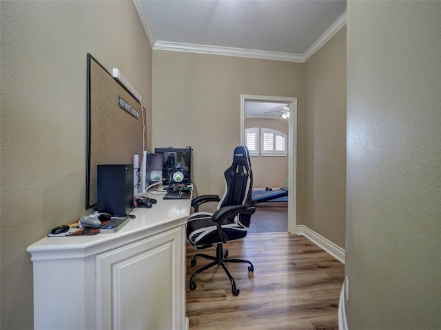 home office with light wood-type flooring, baseboards, and ornamental molding