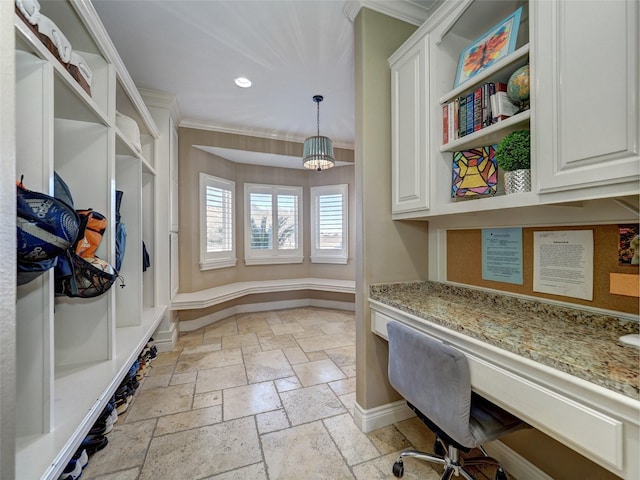 office with stone tile floors, baseboards, ornamental molding, built in desk, and recessed lighting