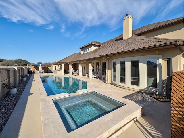 view of pool featuring a fenced backyard, an in ground hot tub, a gazebo, a fenced in pool, and a patio area