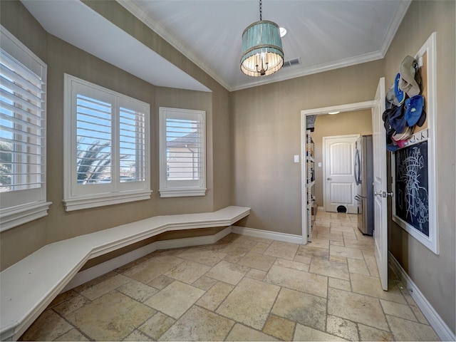 interior space with an inviting chandelier, stone tile flooring, and baseboards