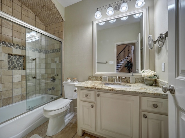 full bath featuring toilet, combined bath / shower with glass door, and vanity