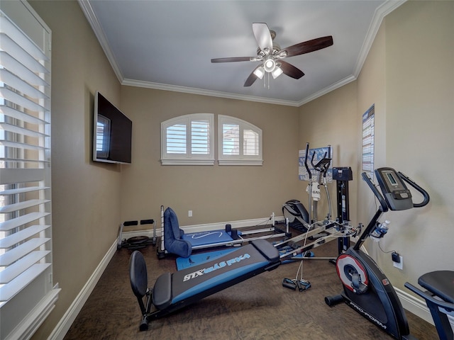 exercise room featuring crown molding, baseboards, and ceiling fan