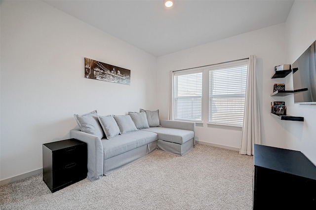 living area with recessed lighting, light colored carpet, and baseboards