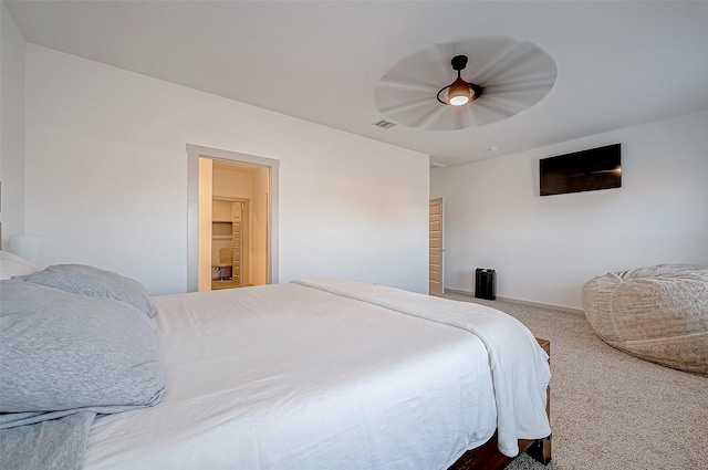 carpeted bedroom featuring visible vents and a ceiling fan