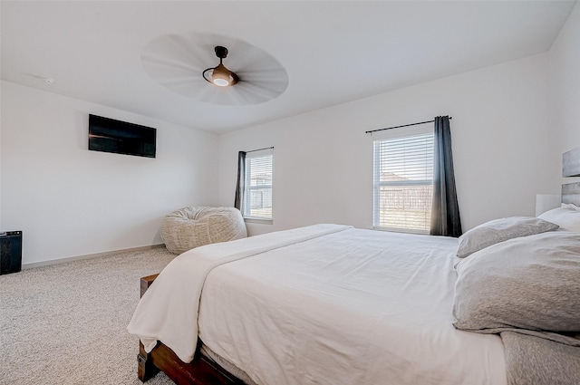 carpeted bedroom featuring ceiling fan and baseboards