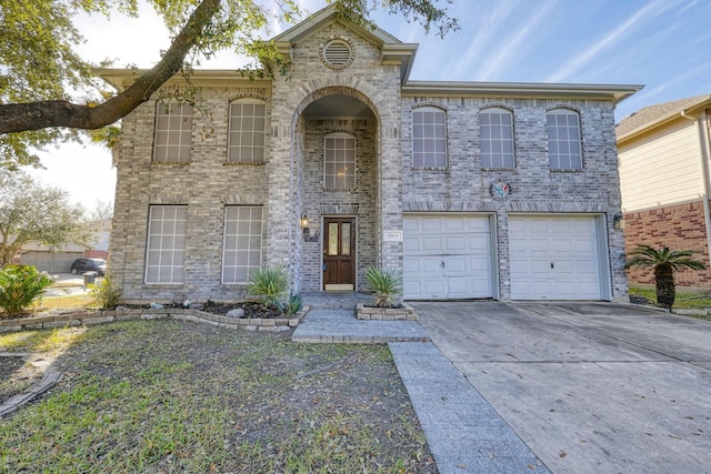 view of front of house featuring driveway, a garage, and brick siding