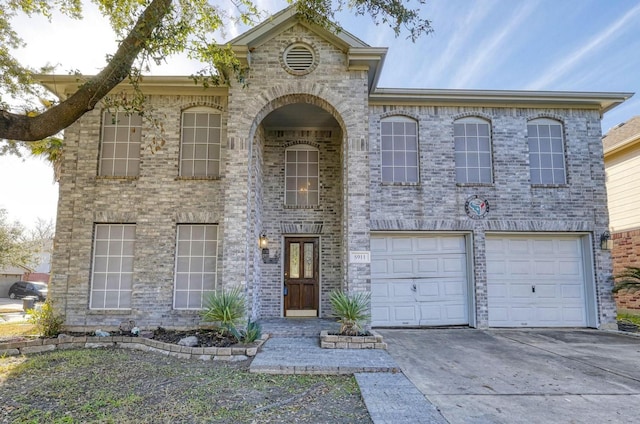 view of front of home featuring driveway, a garage, and brick siding