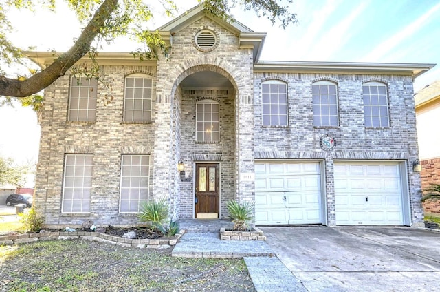 view of front facade with an attached garage, concrete driveway, and brick siding