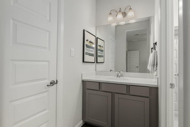 bathroom featuring baseboards and vanity