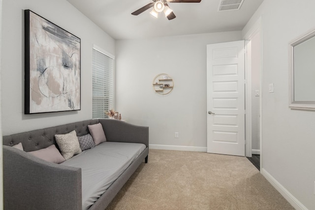 living room featuring light carpet, a ceiling fan, visible vents, and baseboards