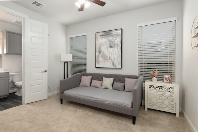 sitting room featuring light carpet, visible vents, and baseboards