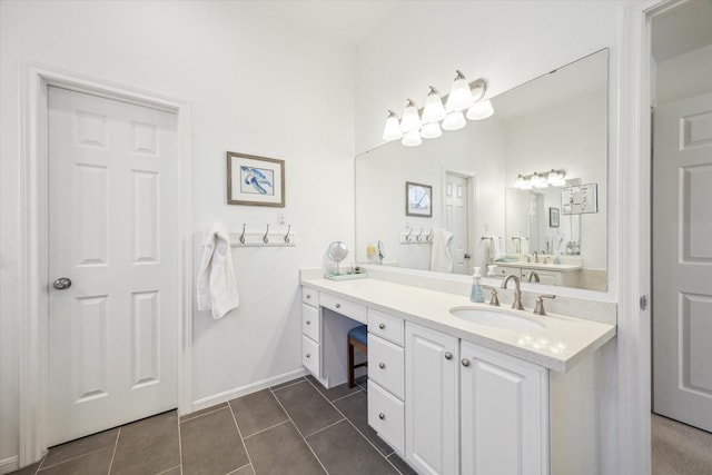 full bath featuring baseboards, vanity, and tile patterned flooring