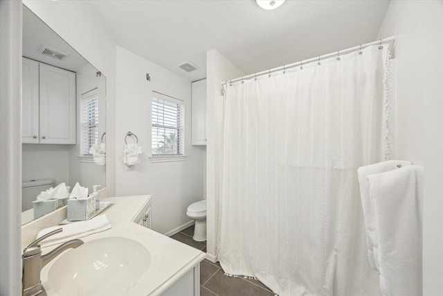 bathroom featuring toilet, vanity, tile patterned floors, and visible vents