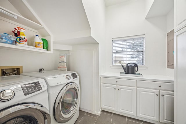 laundry room with tile patterned flooring, washing machine and dryer, and cabinet space