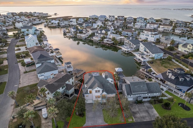 birds eye view of property featuring a residential view and a water view