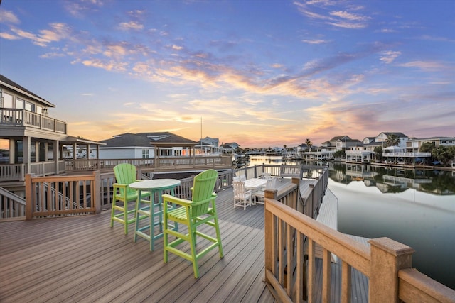 wooden deck with a water view and a residential view