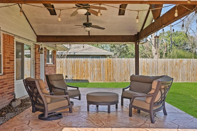 view of patio with ceiling fan and fence