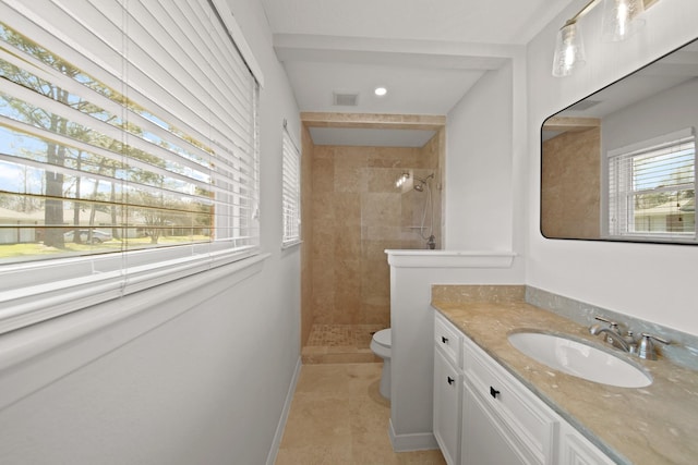 full bath with toilet, vanity, walk in shower, baseboards, and tile patterned floors