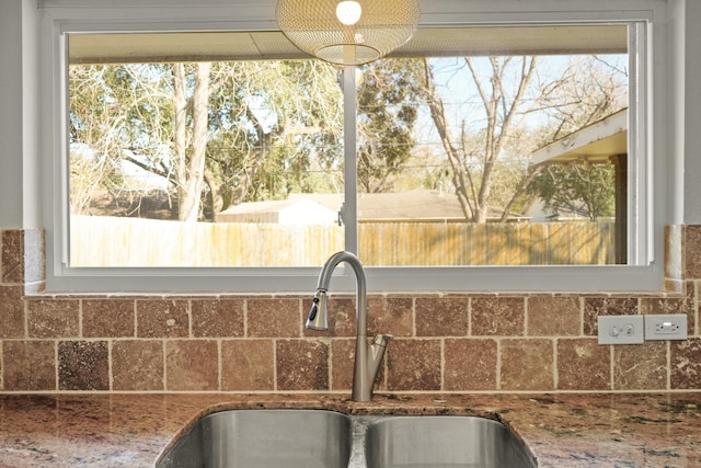 kitchen featuring a wealth of natural light and a sink