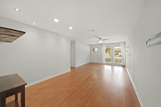 unfurnished living room featuring light wood-type flooring, ceiling fan, baseboards, and recessed lighting