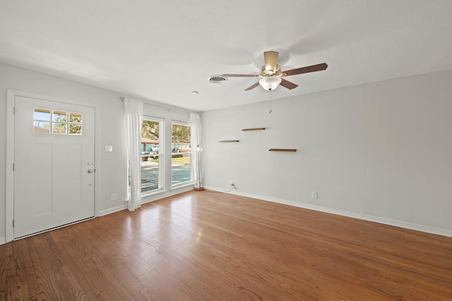 entryway with a ceiling fan, baseboards, and wood finished floors